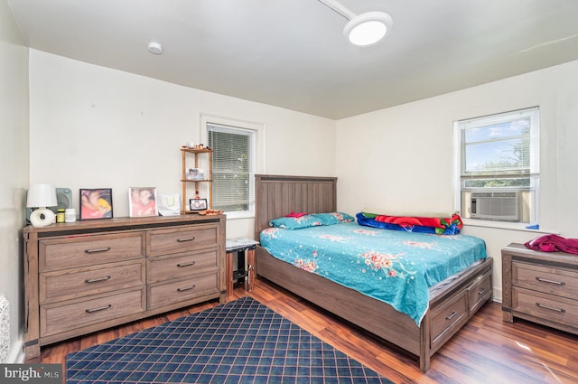 bedroom featuring hardwood / wood-style floors and cooling unit