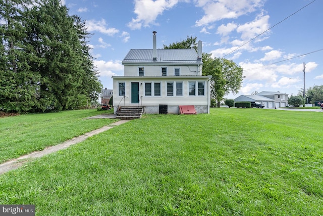 back of house featuring a yard