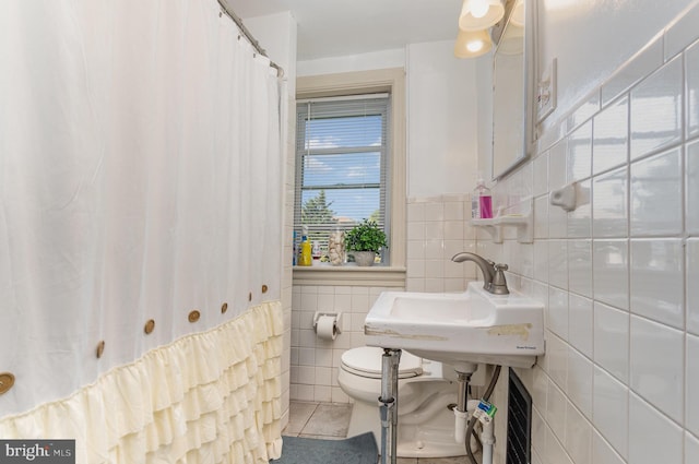 bathroom with sink, tile walls, toilet, and tile patterned floors