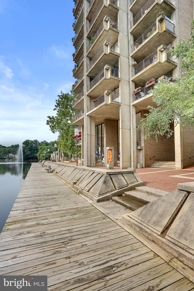 dock area featuring a balcony and a water view