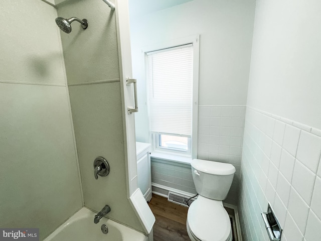 full bathroom with hardwood / wood-style floors, shower / bathtub combination, vanity, tile walls, and toilet