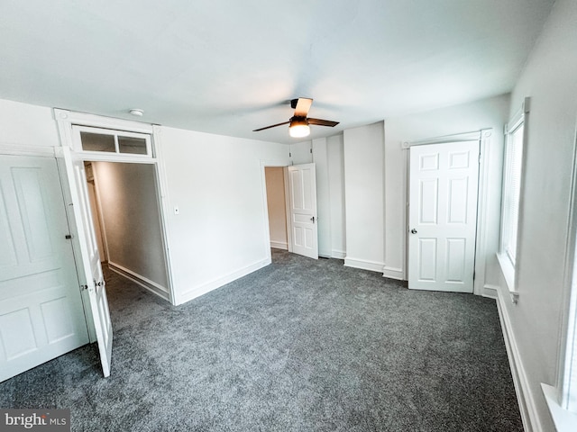 unfurnished bedroom featuring ceiling fan and dark colored carpet