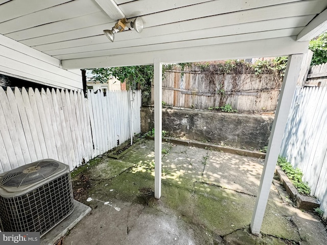 view of patio / terrace with fence and central air condition unit