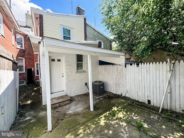 exterior space featuring entry steps, brick siding, and fence private yard