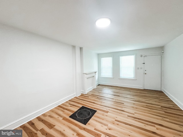 entrance foyer featuring visible vents, light wood-style flooring, and baseboards