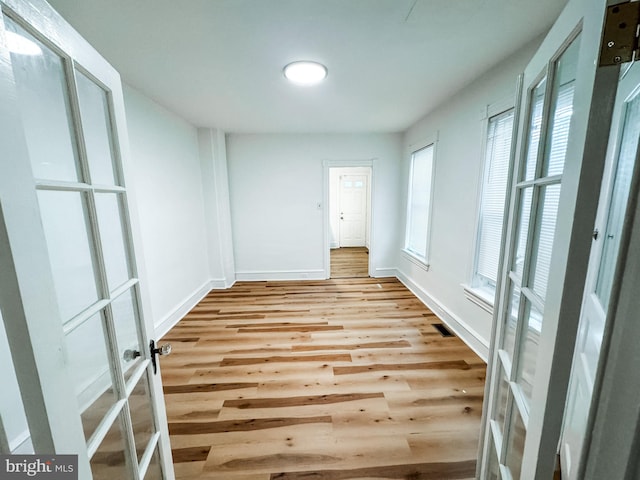 interior space with light hardwood / wood-style flooring and french doors