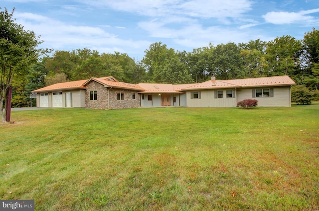 ranch-style house featuring a front yard and a garage