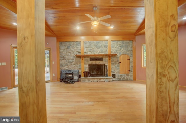 living room featuring wooden ceiling, ceiling fan, and a wealth of natural light