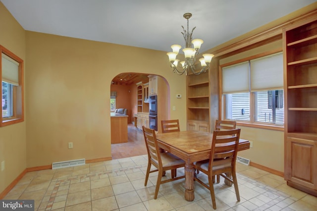 dining room featuring light tile patterned floors and a notable chandelier