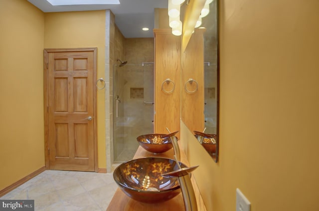 bathroom featuring vanity, tile patterned flooring, and a shower with shower door