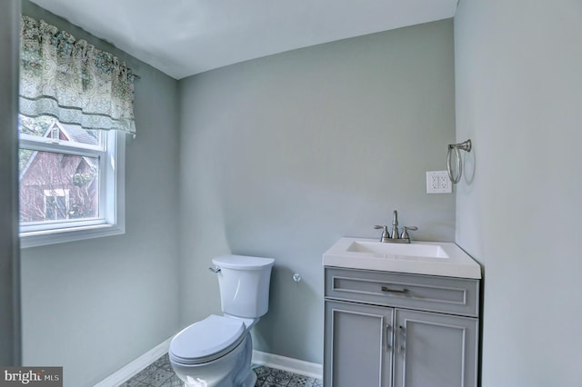 bathroom featuring tile patterned floors, toilet, and vanity