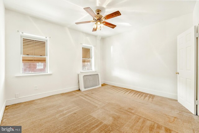 washroom with ceiling fan, light colored carpet, and washer and clothes dryer