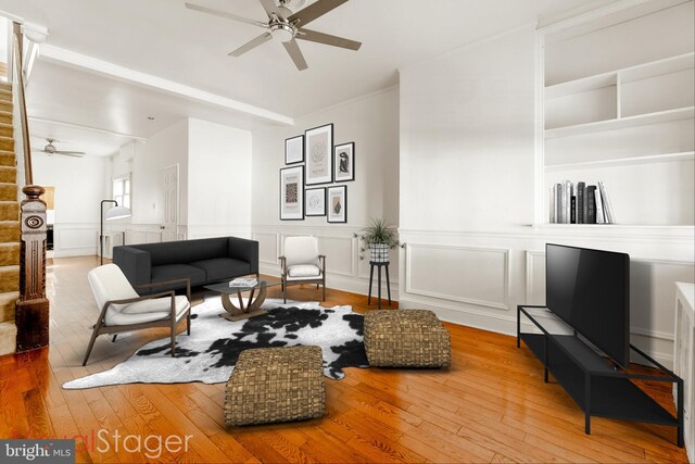 living room with wood-type flooring and ceiling fan