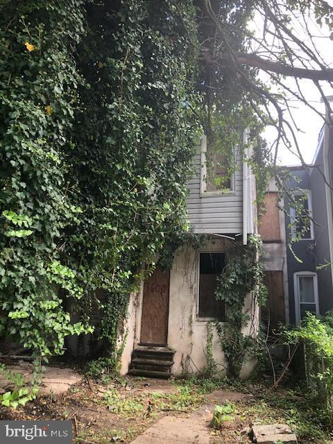 rear view of house featuring entry steps