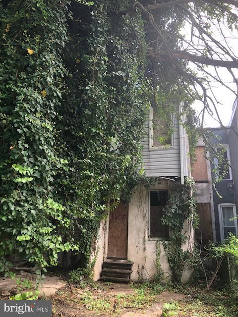 rear view of house featuring entry steps