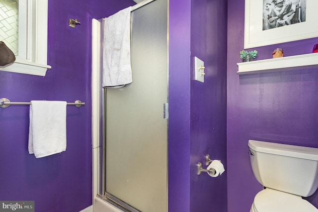 bathroom featuring an enclosed shower and toilet