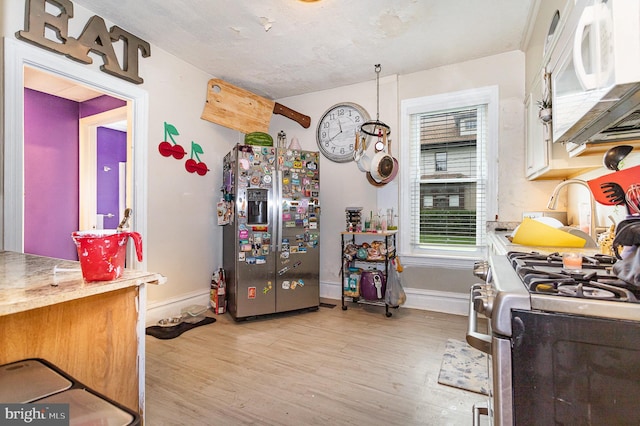 kitchen featuring light hardwood / wood-style flooring and appliances with stainless steel finishes