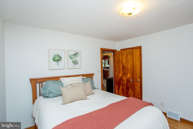 bedroom featuring a closet and light hardwood / wood-style flooring