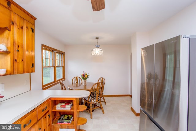 kitchen featuring pendant lighting and stainless steel refrigerator