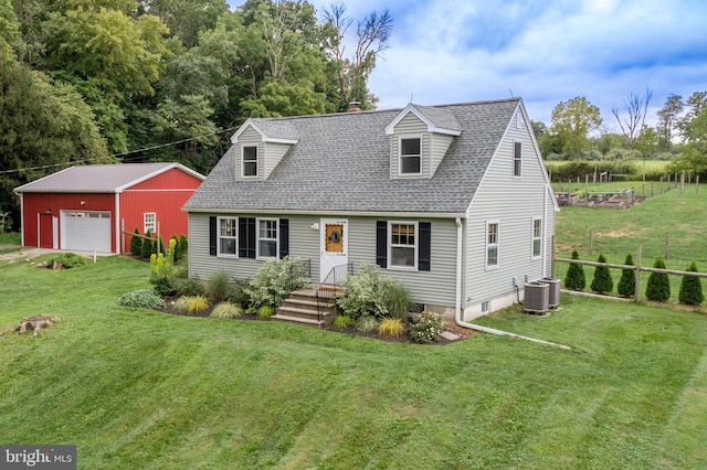 cape cod home with a front lawn, a garage, an outbuilding, and central air condition unit