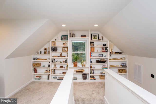 carpeted office space with lofted ceiling