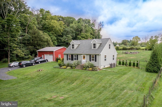 cape cod-style house with central AC, an outdoor structure, a garage, and a front lawn