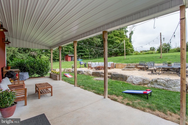 view of patio with a fire pit and a storage unit