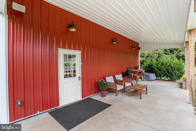 view of exterior entry with a patio area