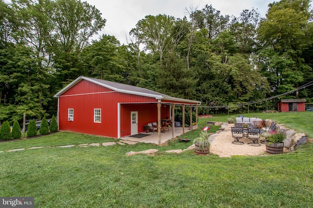 exterior space featuring outdoor lounge area, a storage shed, and a patio area