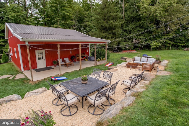 exterior space with outdoor lounge area and an outbuilding