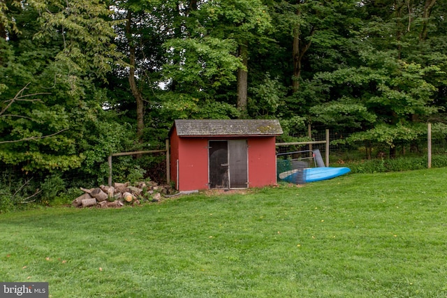 view of outbuilding featuring a yard