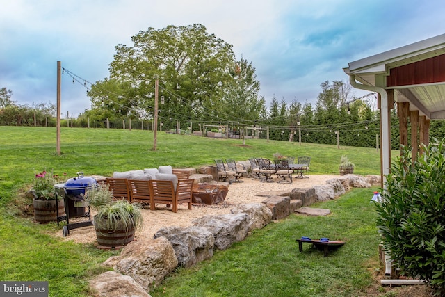 view of yard featuring an outdoor fire pit