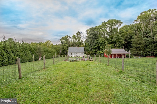 view of yard with a rural view and a shed