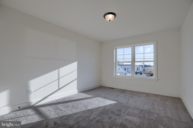 unfurnished room featuring light carpet