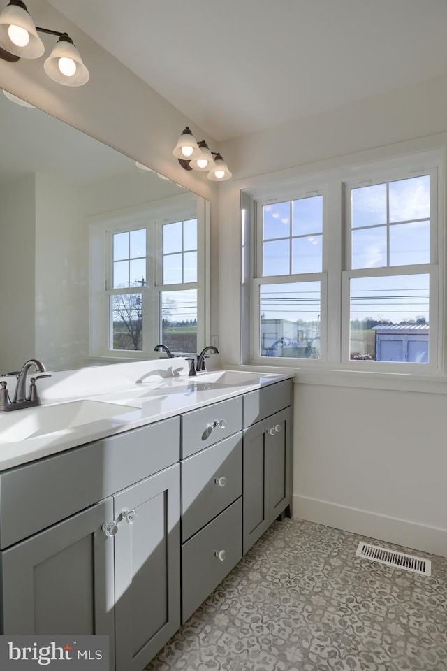 bathroom featuring tile patterned flooring and vanity