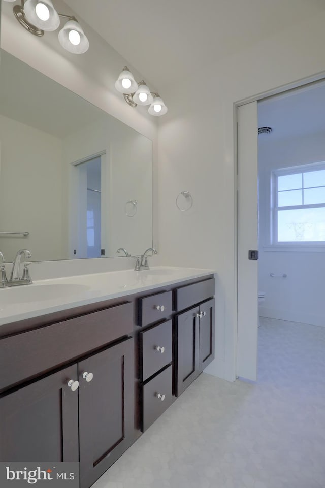 bathroom with toilet and vanity