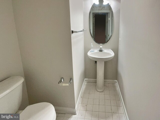 bathroom featuring tile patterned flooring and toilet