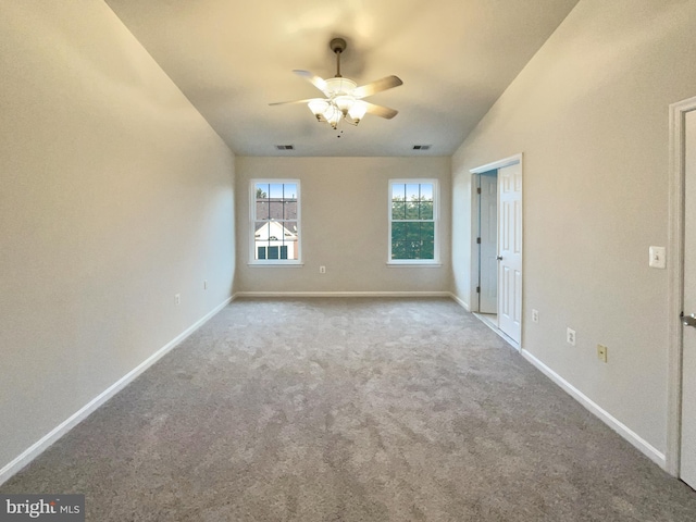 carpeted empty room featuring ceiling fan and vaulted ceiling