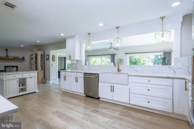 kitchen with sink, light hardwood / wood-style flooring, decorative backsplash, and stainless steel dishwasher