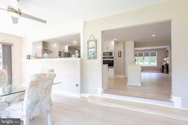 dining area featuring light wood finished floors, baseboards, a ceiling fan, and recessed lighting