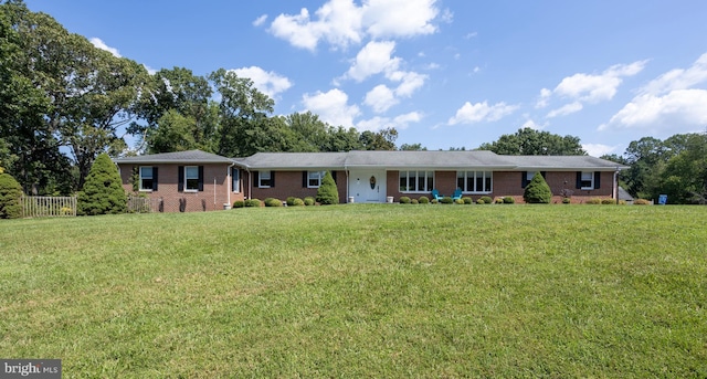 ranch-style home featuring brick siding and a front yard