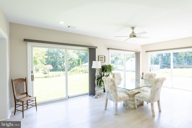 dining room with a ceiling fan, recessed lighting, visible vents, and light wood finished floors