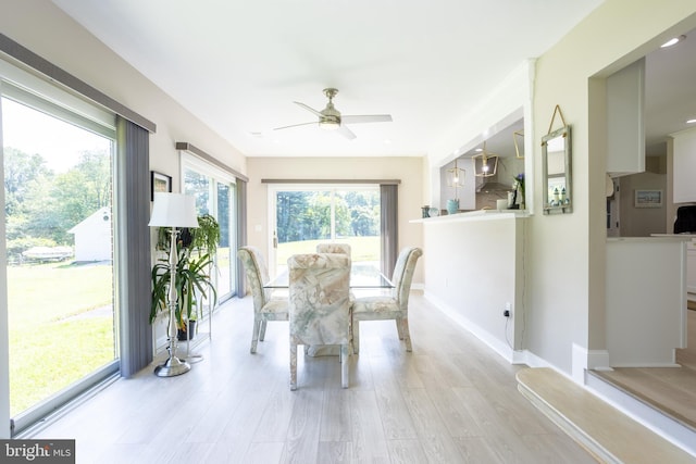 sunroom featuring a ceiling fan