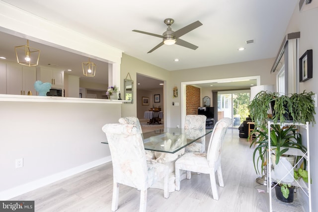 dining room featuring visible vents, light wood-style flooring, and recessed lighting