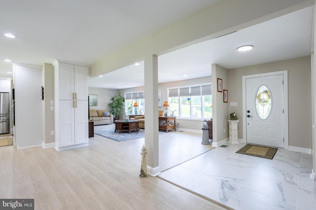 entrance foyer with marble finish floor, recessed lighting, and baseboards