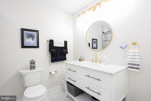 bathroom with marble finish floor, baseboards, vanity, and toilet