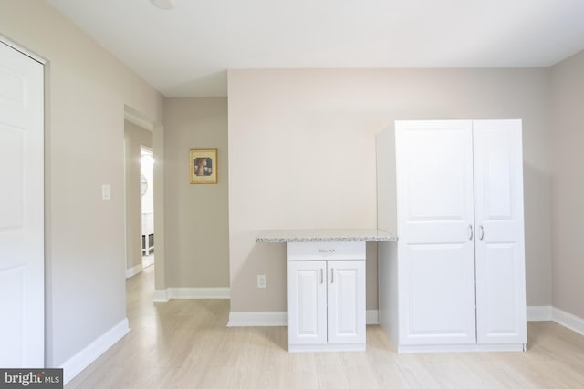 interior space with light wood-type flooring and baseboards