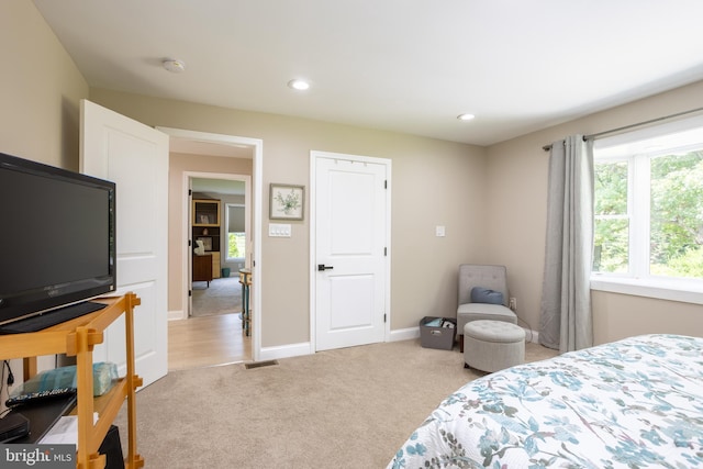 bedroom featuring recessed lighting, light carpet, and baseboards