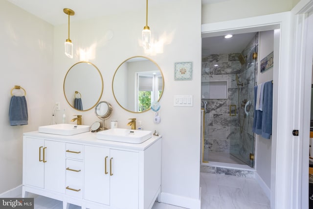 full bathroom featuring a sink, a shower stall, and baseboards