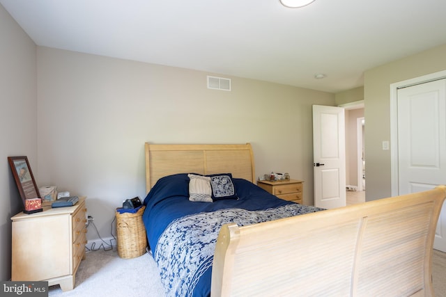 bedroom featuring carpet floors, visible vents, and baseboards